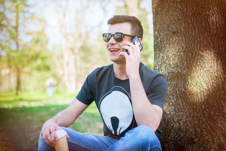 Young man relaxing in the park on a summers dayの写真素材