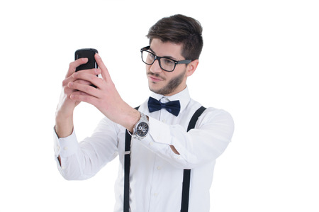 Young man making selfie and smiling, isolated on white backgroundの写真素材