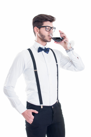 Young man tasting red wine. Isolated on white backgroundの写真素材