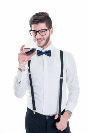 Young happy smiling man with red wine, isolated on whiteの写真素材