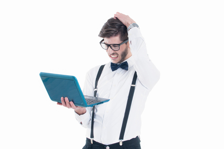 Young business man looking at his laptop with disappointment. Isolated on white backgroundの写真素材