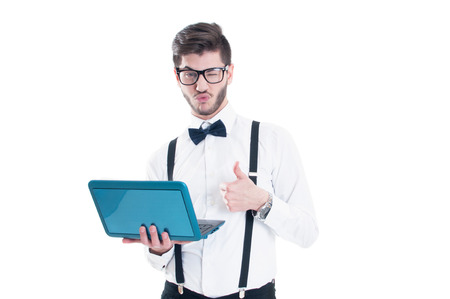 Businessman holding laptop and making the ok gesture. Isolated on white backgroundの写真素材