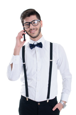 Happy smiling young man talking on mobile isolated on white backgroundの写真素材