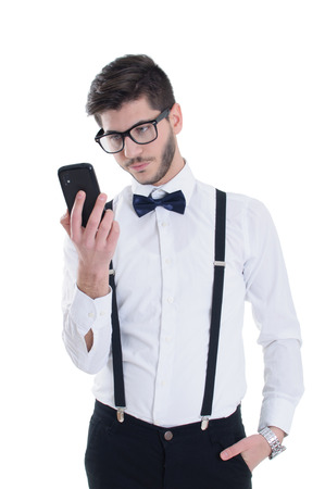 Sad young man looking at mobile phoneの写真素材
