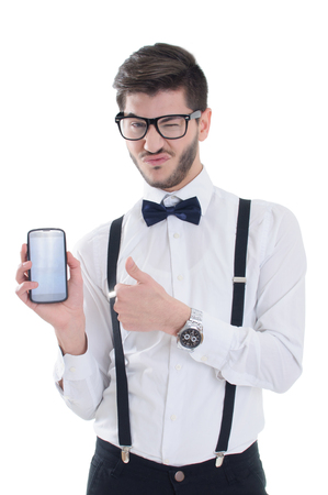 Young man showing a blank smart phone screen with thumbs up isolated on a white backgroundの写真素材
