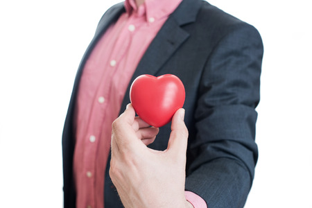 Man holding red heart in his handsの写真素材