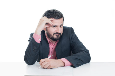 Portrait of a grey hair man with beard, working at home on some projectの写真素材