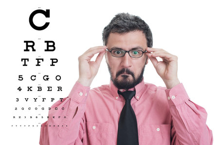 Man taking an eye exam and wearing glasses