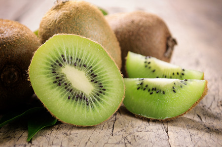 Kiwi fruit on brown wooden backgroundの写真素材