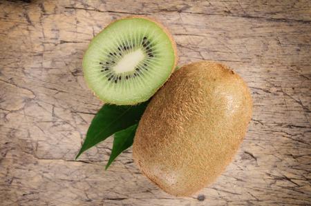 Kiwi fruit on brown wooden backgroundの写真素材