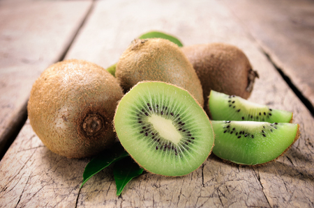 Kiwi fruit on brown wooden backgroundの写真素材