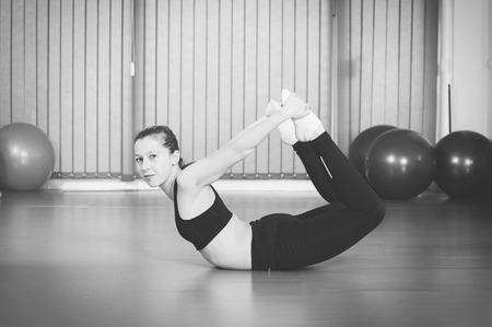Young woman doing yoga exercise, stretchingの写真素材