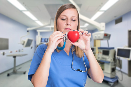 Woman doctor holding a red heartの写真素材