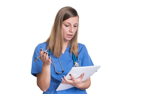 Shocked woman doctor reading her clipboardの写真素材