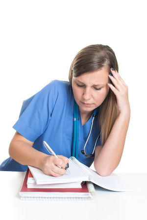 Female doctor studying hard booksの写真素材