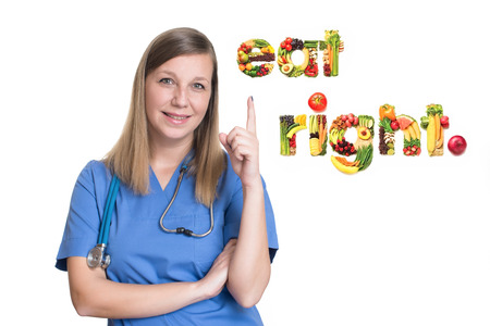 Female doctor pointing up one finger. Eat rightの写真素材