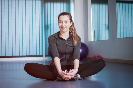 Young woman doing yoga exercise, stretchingの写真素材