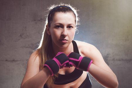 Portrait of a sexy fitness woman ready to fight.の写真素材