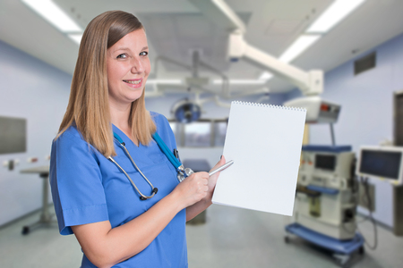 Doctor pointing at blank white paperの写真素材