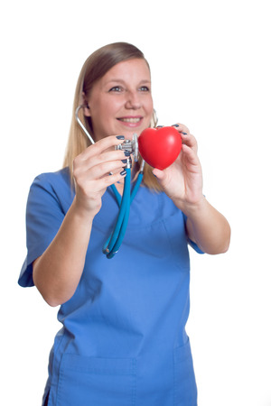 Woman doctor holding a red heartの写真素材