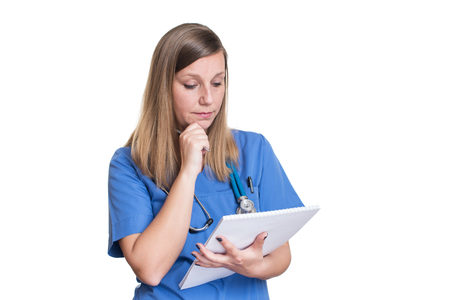 Doctor with stethoscope writing medical reportの写真素材
