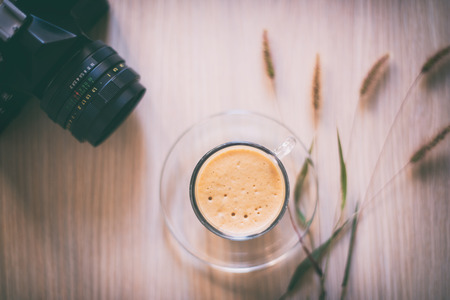 Cup of coffee with retro cameraの写真素材