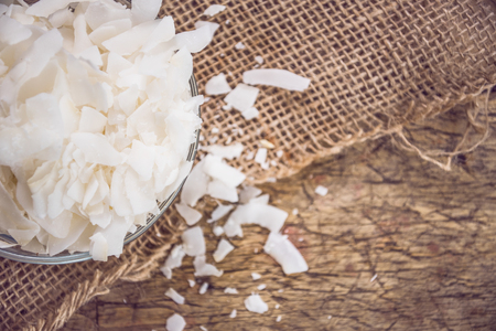 Dried coconut flakes on wooden backgroundの写真素材
