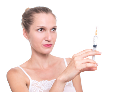 Syringe. Woman holding medical injection in hand, palm or fingersの写真素材
