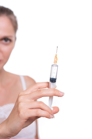 Syringe. Woman holding medical injection in hand, palm or fingersの写真素材