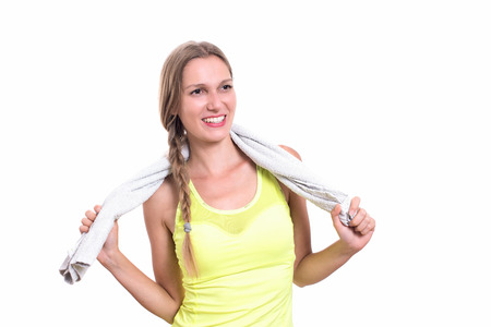 Smiling happy female fitness model with towel on her neckの写真素材
