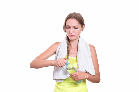 Young gym woman with water bottle smiling isolated on whiteの写真素材