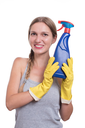Smiling woman holding bottle of chemistry for cleaning houseの写真素材