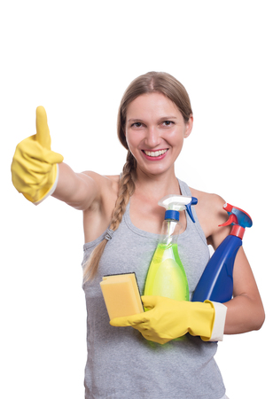 Smiling woman holding bottle of chemistry for cleaning houseの写真素材