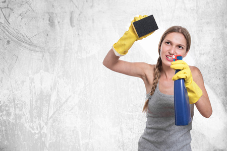 Young housewife woman cleaning, isolated on white backgroundの写真素材