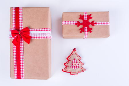 Wrapped vintage gift boxes with red ribbon bow and Christmas ornamentsの写真素材