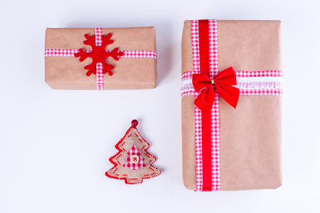 Wrapped vintage gift boxes with red ribbon bow and Christmas ornamentsの写真素材