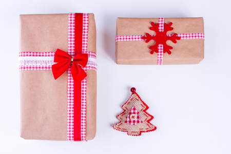 Wrapped vintage gift boxes with red ribbon bow and Christmas ornamentsの写真素材