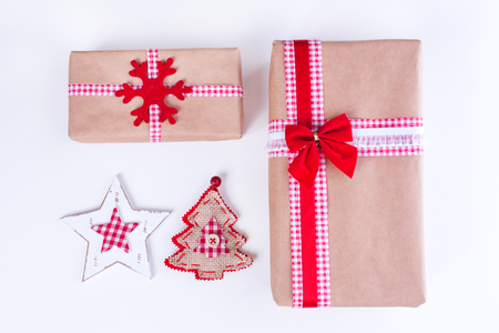 Wrapped vintage gift boxes with red ribbon bow and Christmas ornamentsの写真素材