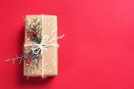 Christmas gift box on red backgroundの写真素材
