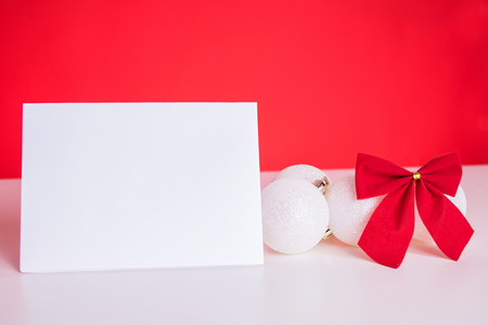 Christmas balls and red ribbon on red backgroundの写真素材