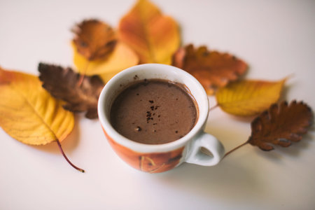 Coffee Cup Surrounded By Autumn Leaves On Table