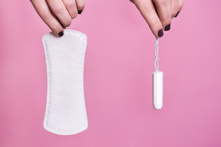 Women holding a sanitary napkin and tamponの写真素材