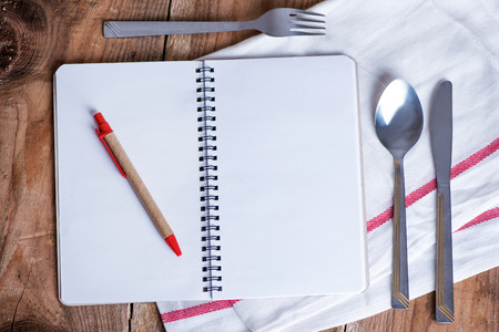 Blank recipe book on wooden tableの写真素材