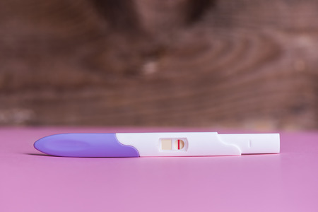 Negative pregnency test on pink backgroundの写真素材
