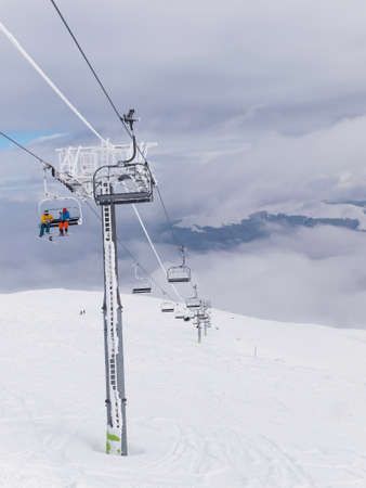 A cableway with chairlift in a winter dayの写真素材