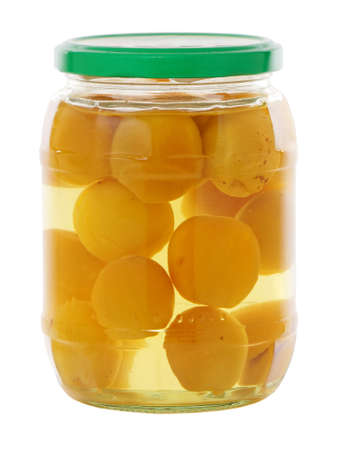 Apricot compote in a glass jar isolated on whiteの写真素材