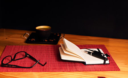 Work table with notebook and penの写真素材
