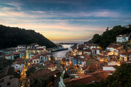 Beautiful view of coastal Asturias sea village Cudilleroin Spain, Europe during sunset or dusk. Gorgeous panorama of nature traditional famous touristic summer destination at dusk or dawn.の写真素材