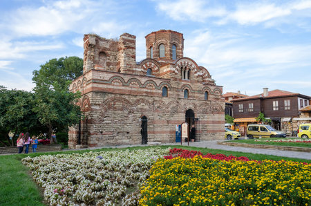 Nesebar, Bulgaria - September 20, 2014: Byzantine era of Christ Pantocrator in old town of Nesebar with small garden in front and small group of people walking aroundのeditorial素材