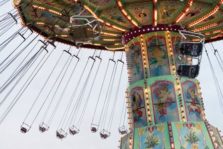 Vienna, Austria - January 01, 2018: Side view of the moving Luftikus carousel or chain swing ride at overcast day, Prater amusement parkのeditorial素材
